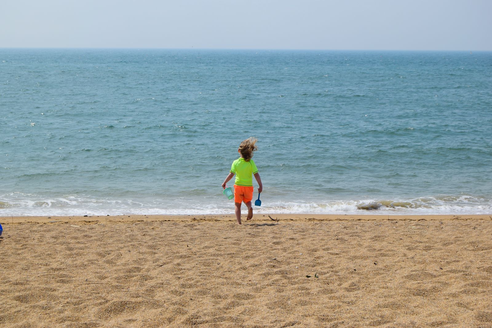 Splashy times: little guy gets in the sea.